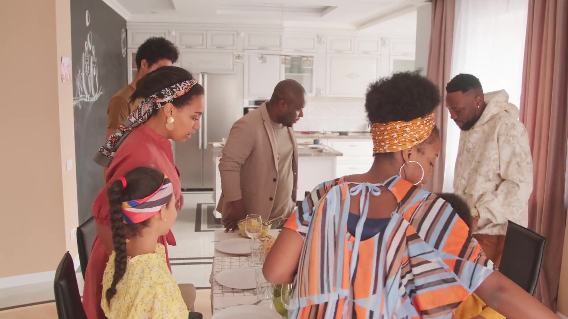 Friends and family around a dinner table filled with dishes
